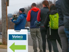 People line up to vote in the Calgary municipal election on Oct. 18, 2021.