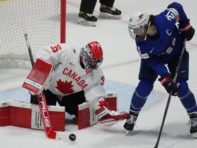 Canada goaltender Ann-Renee Desbiens (35) makes a save against United States' Hilary Knight (21) during first period hockey action at the IIHF Women's World Hockey Championship in Utica, N.Y., Monday, April 8, 2024.