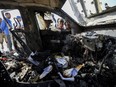 People inspect the site where World Central Kitchen workers were killed in Deir al-Balah, Gaza Strip, April 2, 2024. World Central Kitchen, the food charity founded by celebrity chef José Andrés, called a halt to its work in the Gaza Strip after an Israeli strike killed seven of its workers, mostly foreigners.