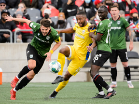 Malcolm Shaw of Atlético Ottawa, centre, is pictured during a match against Calvary FC on April 9, 2022. Shaw has now joined Cavalry.
