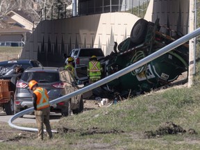 Emergency crews work on a rolled vacuum truck on the offramp from northbound Macleod Trail to Stoney Trail S.E. in Calgary on Tuesday, April 23, 2024.