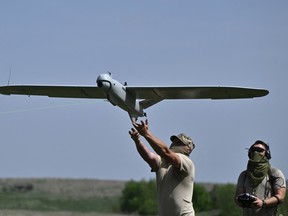 Ukrainian servicemen launch a Leleka reconnaissance UAV drone