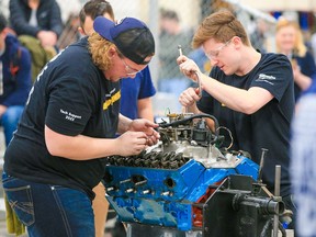 Competitors race to assemble an engine at last year's World of Wheels at the BMO Centre.