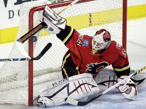 Miikka Kiprusoff of the Calgary Flames makes a stop against Michael Frolik of the Florida Panthers.