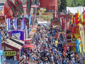 People enjoy the hot and sunny afternoon at Stampede grounds on Friday, July 15, 2022. Azin Ghaffari/Postmedia