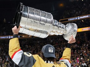Ben Hutton of the Vegas Golden Knights celebrates with the Stanley Cup after victory over the Florida Panther in Game Five of the 2023 NHL Stanley Cup Final at T-Mobile Arena on June 13, 2023 in Las Vegas, Nevada.