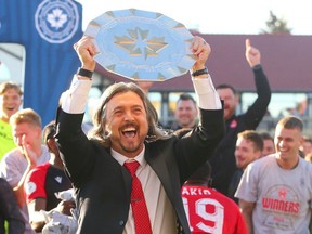 Cavalry FC GM/head coach Tommy Wheeldon Jr. hoists the Canadian Premier League Shield as the club celebrates its regular-season title on on ATCO Field at Spruce Meadows on Oct. 7, 2023.