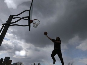 Tanner Zaherie gets in some hoop action in Bridgeland under threatening skies in northeast Calgary on Friday, May 3, 2024. He tries to get on the court at least three times per week.