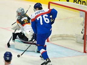 Slovakia's forward #76 Martin Pospisil (R) and Germany's goalkeeper #30 Philipp Grubauer vie for the puck during the IIHF Ice Hockey Men's World Championships match between Slovakia and Germany in Ostrava, Czech Republic on May 10, 2024.