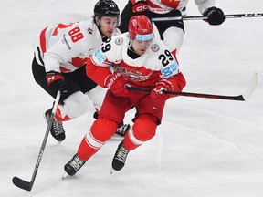 Canada forward Andrew Mangiapane vies for a puck with Denmark forward Mikkel Aagaard during IIHF World Championship in Prague on May 12, 2024.