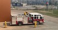 Firefighters inspect a fire truck in Fort McMurray on May 15, 2024. Image supplied by RMWB