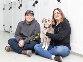 Parachutes for Pets social enterprise coordinator Brandon Montague and founder Melissa David pose with canine client Ruby at their Pet Advocacy Centre off 1A Street S.W. in Calgary on Tuesday, May 21, 2024.