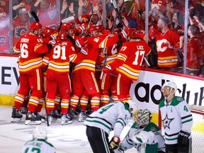 The Calgary Flames celebrate Johnny Gaudreau’s overtime goal against the Dallas Stars in Game 7 of their first-round playoff series at the Scotiabank Saddledome in Calgary on May 15, 2022.