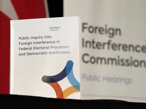 A copy of the interim report is seen on a table following its release at the Public Inquiry Into Foreign Interference in Federal Electoral Processes and Democratic Institutions, in Ottawa, Friday, May 3, 2024.