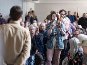 Members of the public ask questions in a flood mitigation forum organized by the Glenbow Ranch Park Foundation at the Frank Wills Community Hall in Cochrane, Alta., on Saturday, May 4, 2024.