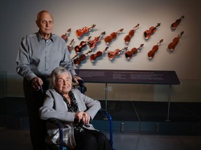 Holocaust survivor Irene Ross and her husband Stuart tour the new Violins of Hope exhibit at the National Music Centre on Friday May 3, 2024. Violins of Hope is an exhibition and collection of historic string instruments from before and during the Holocaust. The restored instruments once belonged to Jewish victims and survivors of the Holocaust. Gavin Young/Postmedia