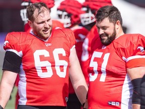 Calgary Stampeders offensive linemen Bryce Bell, left, and Sean McEwen chat on the sidelines during practice at McMahon Stadium on Thursday, May 16, 2024. Brent Calver/Postmedia
