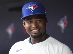 Orelvis Martinez #13 of the Toronto Blue Jays smiles from the dugout after being called up to the team from the minor leagues ahead of playing against the Boston Red Sox in their MLB game at the Rogers Centre on June 18, 2024 in Toronto.