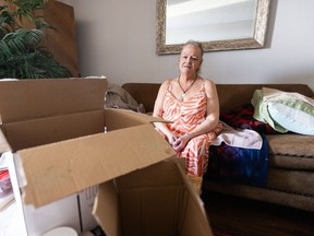Kim Gillespie sits among half-packed belongings in her southwest Calgary apartment on May 29. Gillespie said rents in her building, owned by Avenue Living, spiked over the past two years, and had she not found another place to live at the end of May, she could have ended up homeless.