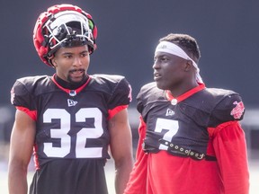 Defensive back Titus Wall, left, speaks with linebacker Micah Awe during Calgary Stampeders’ training camp on May 16, 2024.