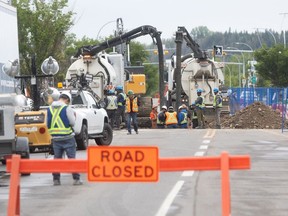 Machinery and road crews work on 16 Avenue N.W. between 45 and 46 Streets in Calgary on Monday, June 17, 2024 to repair a segment of a damaged water feeder main. The crisis began on June 5 when the 2-metre-wide pipe running under 16 Avenue ruptured near Home Road in Montgomery, with five additional weak points being identified. Brent Calver/Postmedia