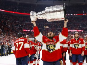 Ryan Lomberg #94 of the Florida Panthers yells while lifting the Stanley Cup after Florida's 2-1 victory against the Edmonton Oilers in Game Seven of the 2024 Stanley Cup Final at Amerant Bank Arena on June 24, 2024 in Sunrise, Florida.