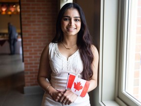 New Canadian Harleen Mann poses for a photo following her citizenship ceremony hosted by Heritage Park in Calgary on Monday, July 1, 2024.