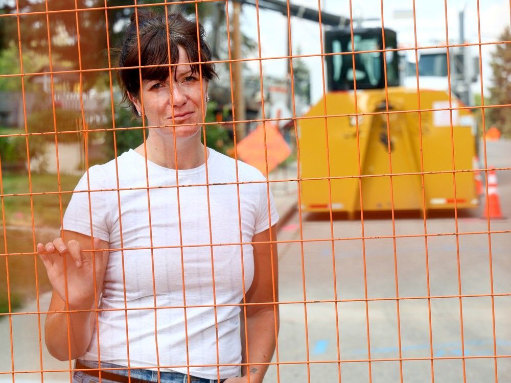 Bowness resident Christina Pilarski, who'll be affected by the water main work on 33rd Avenue, has unanswered questions about construction impacts. Pilarski is seen near a work site on Thursday, August 22, 2024.