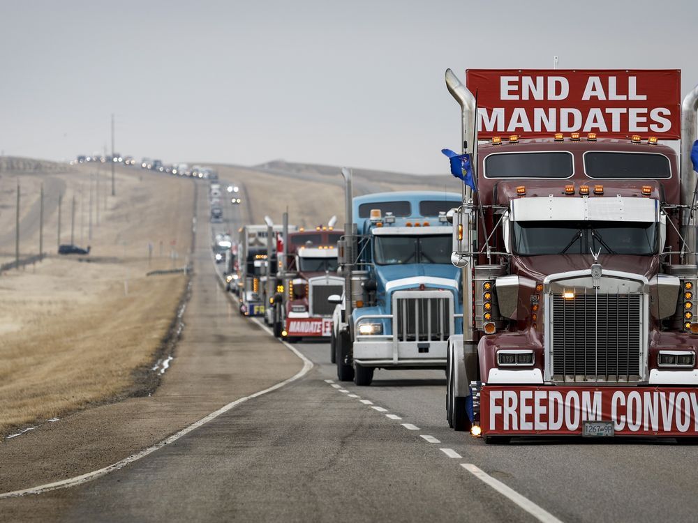 Anti-COVID-19 vaccine mandate demonstrators leave in a truck convoy after blocking the highway at the busy U.S. border crossing in Coutts, Alta., Tuesday, Feb. 15, 2022. A judge is expected to hand down sentences today for two men convicted for their roles at the blockade.