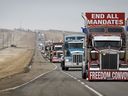 Anti-COVID-19 vaccine mandate demonstrators leave in a truck convoy after blocking the highway at the busy U.S. border crossing in Coutts, Alta., Tuesday, Feb. 15, 2022. A judge is expected to hand down sentences today for two men convicted for their roles at the blockade.