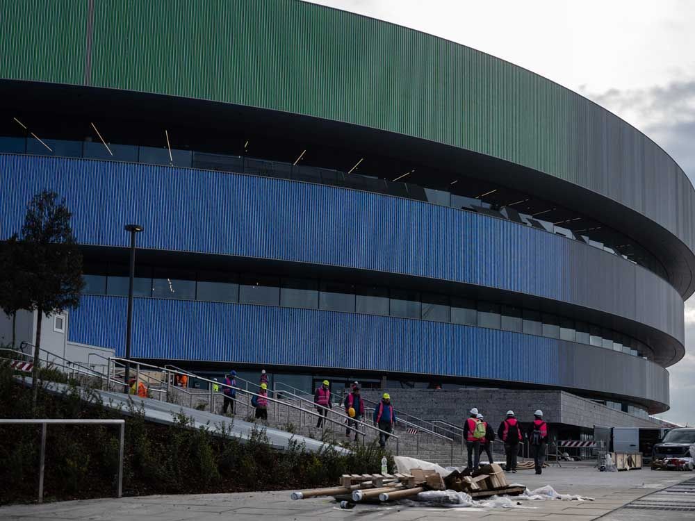 The IOC say "frantic" work is underway to complete construction of an arena set to host the world's top hockey players. Read more.