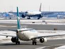 Two planes cross paths -- at a distance -- at YYC in this file photo from 2020.