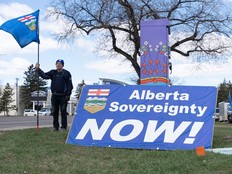A separatist supporter holds a flag during a rally near the Elections Alberta headquarters in Edmonton, Canada, on May 4, 2026. Two recent polls show a large majority of Albertans do not support separating from Canada.