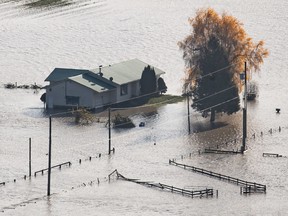 Canadians have faced their share of crises recently, from the COVID-19 pandemic to climate-related floods and wildfires. Above is a house surrounded by floodwaters in Abbotsford, B.C., on Nov. 17.