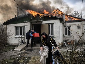 People remove personal belongings from house after being shelled outside Kyiv, on March 4.
