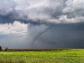 Tornado and dark storm clouds over a farm field. From climate to development regulation and trade tariffs, farmland investors face an abundance of risks along with the upsides of this alternative asset.