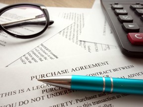Purchase agreement document for filling and signing on desk. Direct investing involves weighing expertise, risk tolerance and budget.