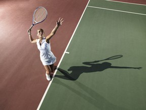 A view from above as a woman serves a tennis ball on a court. Improving your tennis game requires practice, but make sure you are practising the right things, according to tips from one pro.