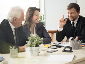 A younger man and woman sit at a board table with an older man. While 70 per cent of family businesses would like to pass their business on to the next generation, only 30 per cent will be successful, according to the Family Firm Institute.