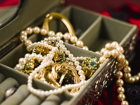 Jewels spill out of a jewellery box. While some of the pieces may never be worn, jewellery represents family legacy, which can be passed on from generation to generation in memory of the donor.