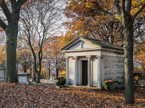 A mausoleum and several tombstones in a graveyeard surrounded by fall foliage. Looking for multigenerational burial plots is like real estate, experts say. ‘You’re looking for the square footage of the land, how many burials are allowed per lot, including burial of ashes and burials of caskets.’
