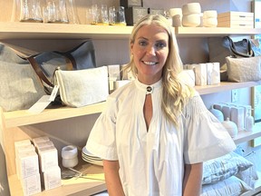 Designer Sarah Baeumler stands in front of some of her lifestyle-brand items, such as pillows and glasses. :‘Women have always, and continue to, make significant contributions to the success of … family businesses.’