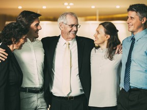 Closeup of smiling senior business man embracing colleagues. They are standing and with blurred view in background. Having a successful family business doesn’t always mean this will translate into those same people achieving the goals of the family office, so it’s important to assess those roles independently, experts say.