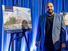 Sam Ibrahim, president of Scarborough-based Arrow Group of Companies, stands next to a poster of the an artist's rendering of the building that will be created because he recently donated $25 million to create the Sam Ibrahim Centre of Inclusive Excellence in Entrepreneurship, Innovation and Leadership at the University of Toronto’s Scarborough campus so other locals could build up their ventures and their community: “No one was coming to save us and that mentality still shapes me now.”