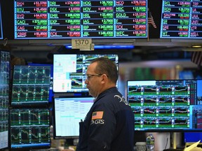 A trader works on the floor of the New York Stock Exchange during morning trading.