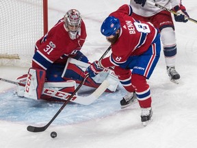 Montreal Canadiens defenceman Jordie Benn clears the puck in front of the net of Carey Price against the Columbus Blue Jackets at the Bell Centre in Montreal on Monday, November 27, 2017.