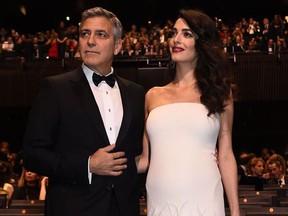 US actor George Clooney (L) and his wife British-Lebanese lawyer Amal Clooney pose as they arrive for the 42nd edition of the Cesar Ceremony at the Salle Pleyel in Paris on February 24, 2017.        (BERTRAND GUAY/AFP/Getty Images)