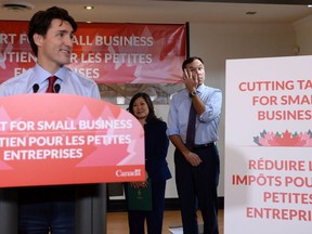 Prime Minister Justin Trudeau speaks to members of the media as Finance Minister Bill Morneau looks on at a press conference on tax reforms in Stouffville, Ont., on Monday, October 16, 2017.