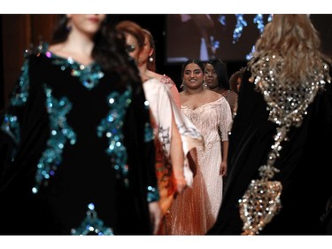 Plus-size models present creations during a fashion show as part of a day against fat phobia in Paris, France, Friday, Dec. 15, 2017.