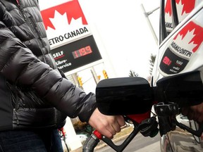 Ottawa resident David Allard watches the dollars rack up as he filled his tank at a Petro-Canada station on April 12, 2017.